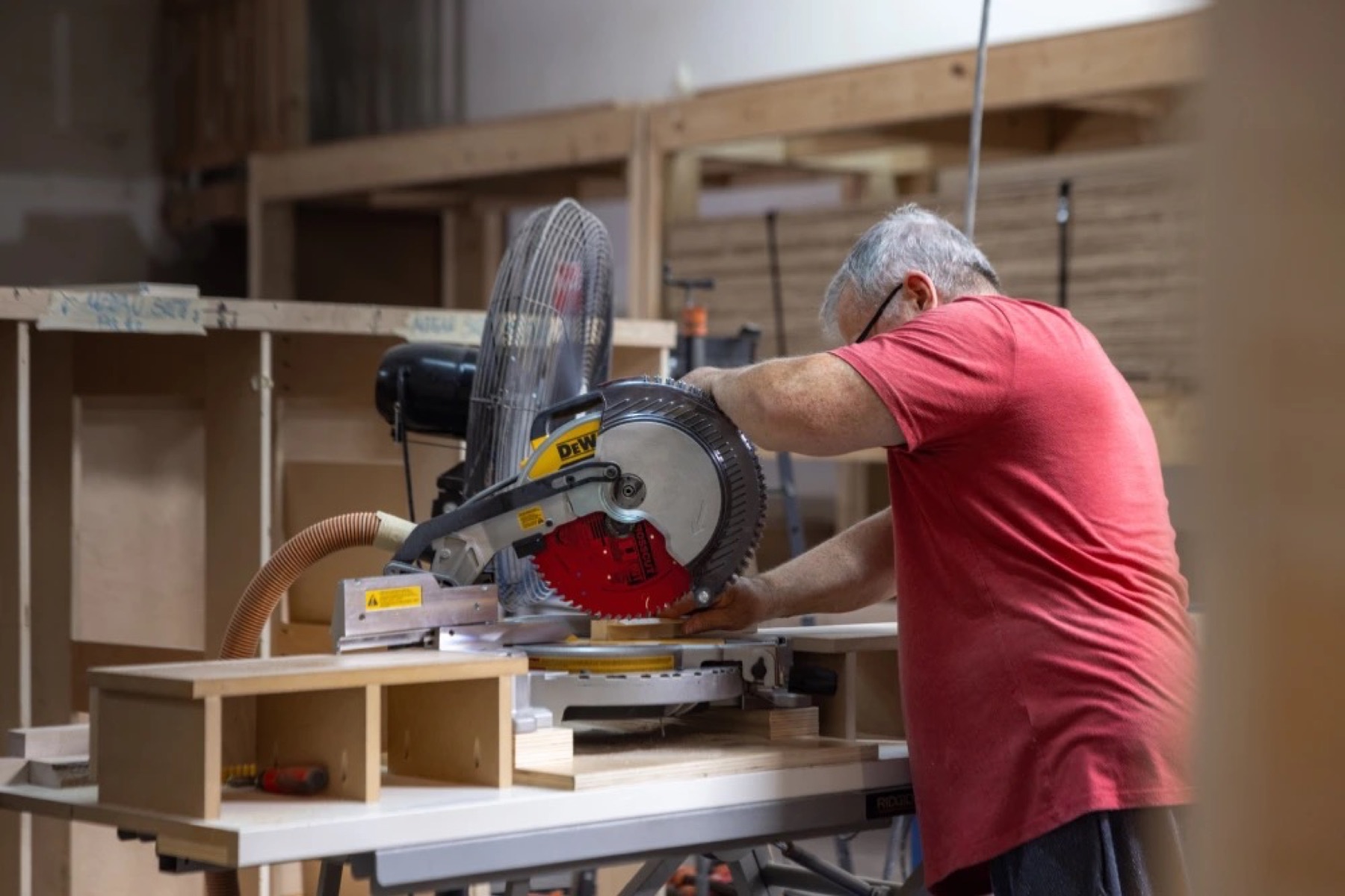 A craftsman cutting millwork in the shop