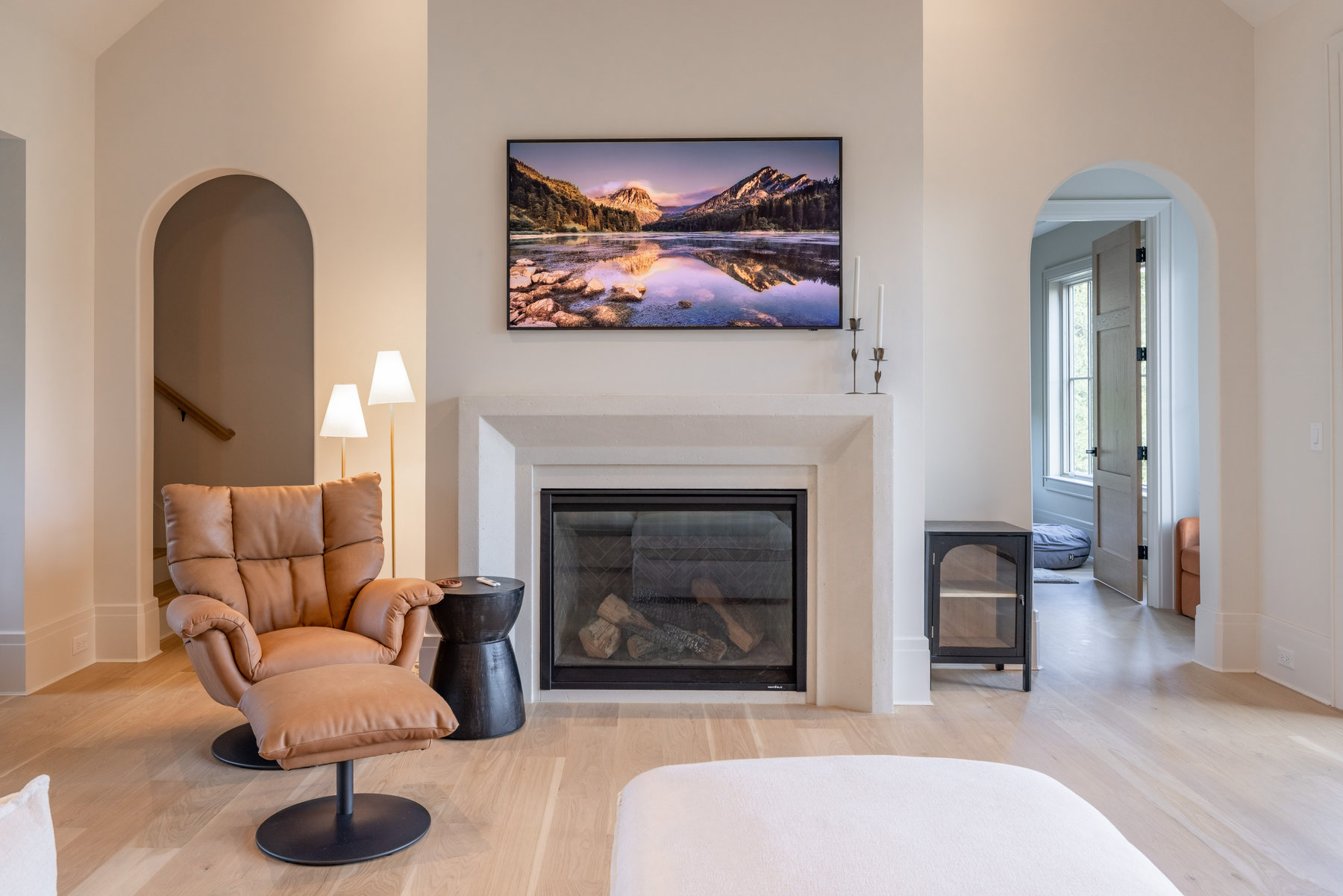 Living room with carved stone fireplace surround
